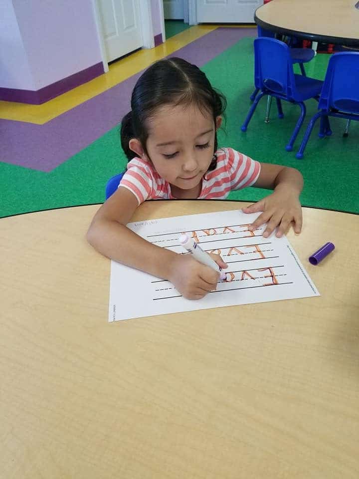 Girl practicing writing at the Learn n' Play preschool